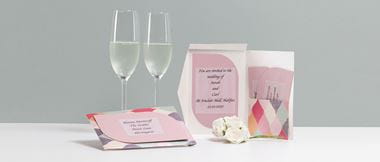 Wedding invite opened up with two champagne glasses