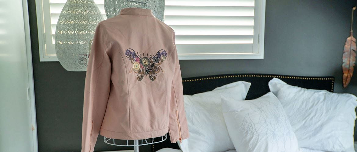 pink pleather jacket with large steampunk buttery embroidered on back