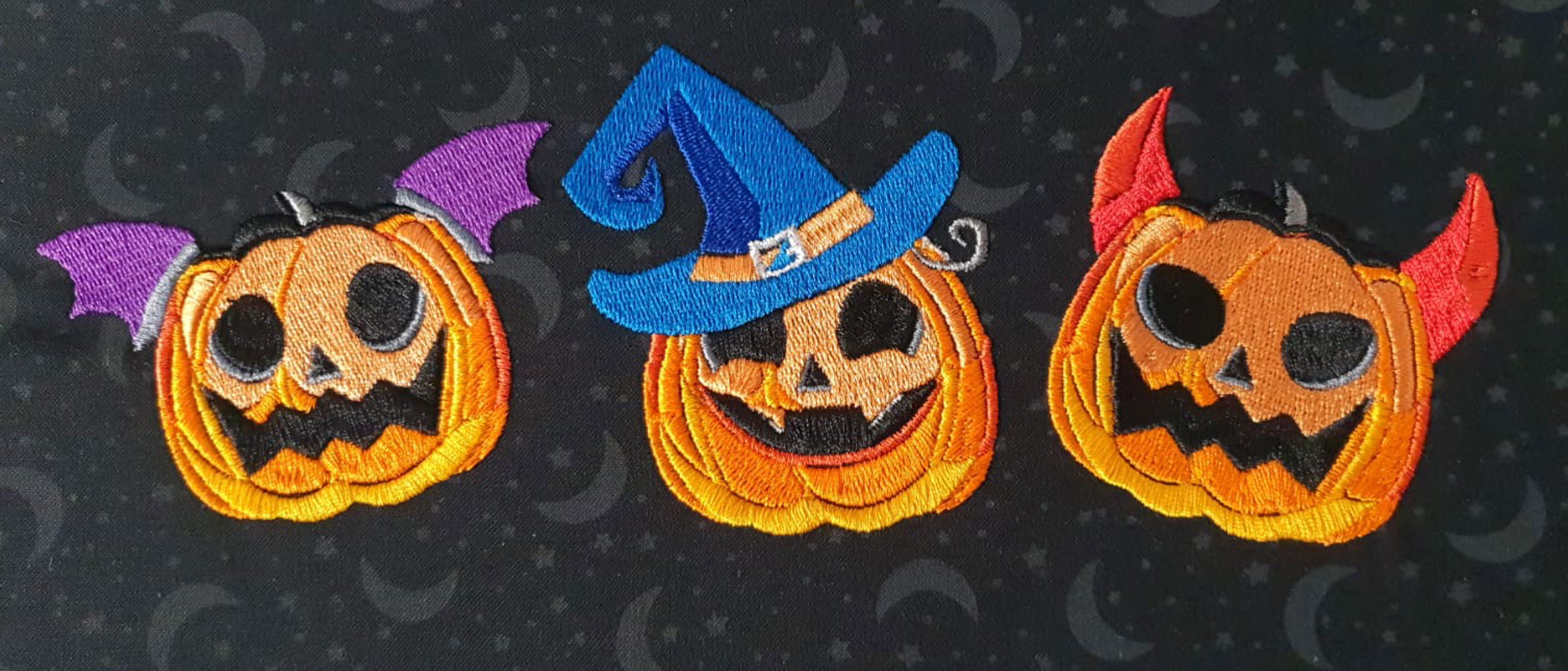 three embroidered pumpkins with faces in animated style