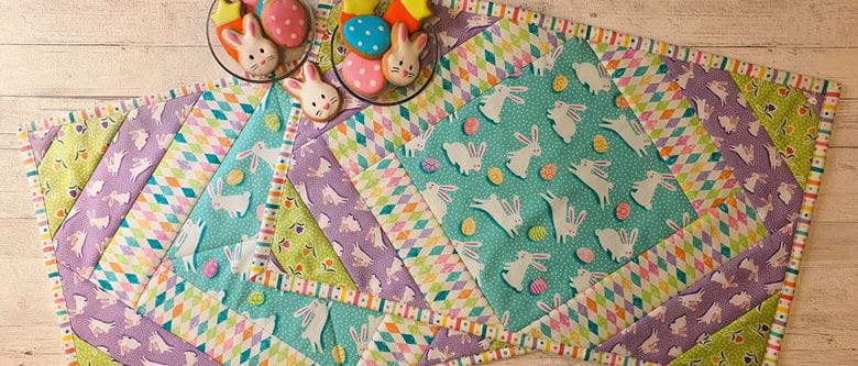 Colourful quilted placemats on wooden background