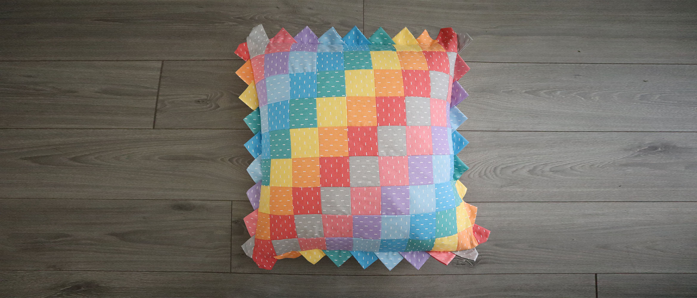 Patchwork Prairie Point Edge Cushion in Pastel Rainbow Fabrics