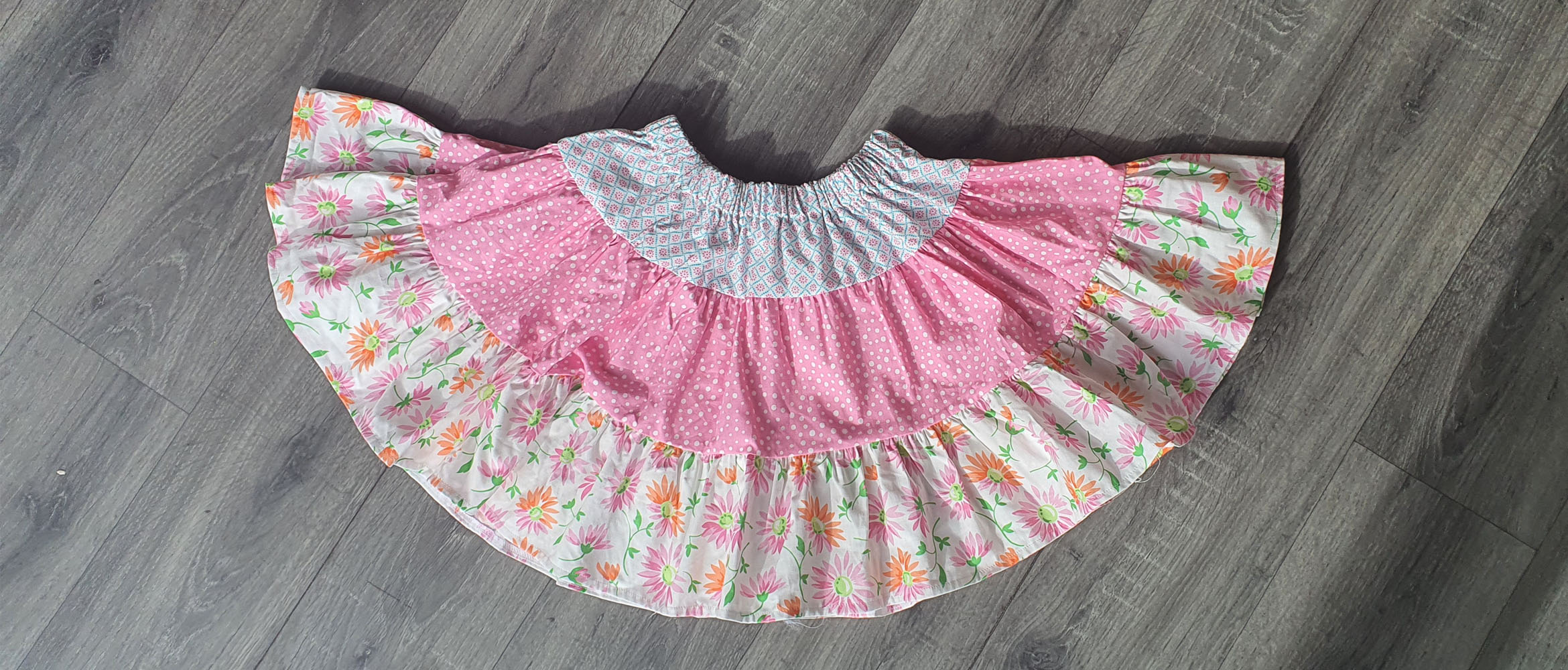 Ruffled skirt on wooden background