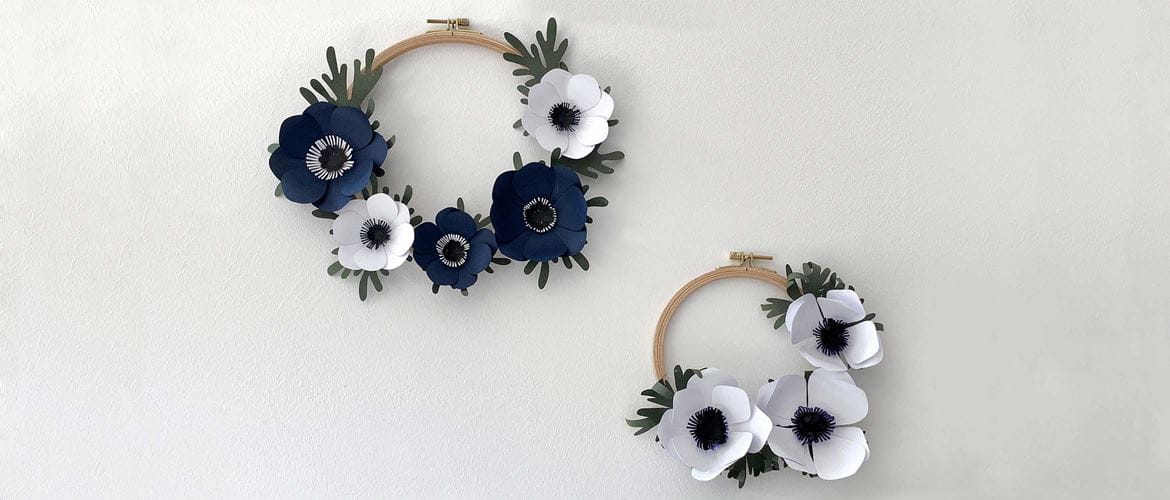 Blue and white paper anemone flowers on wooden embroidery hoop