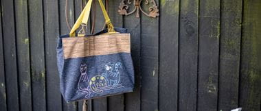 cartoon cats embroidered onto Demin bag