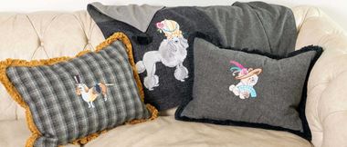dog embroidered pillows and throw on beige sofa