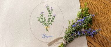 linen placemat with embroidered thyme motif