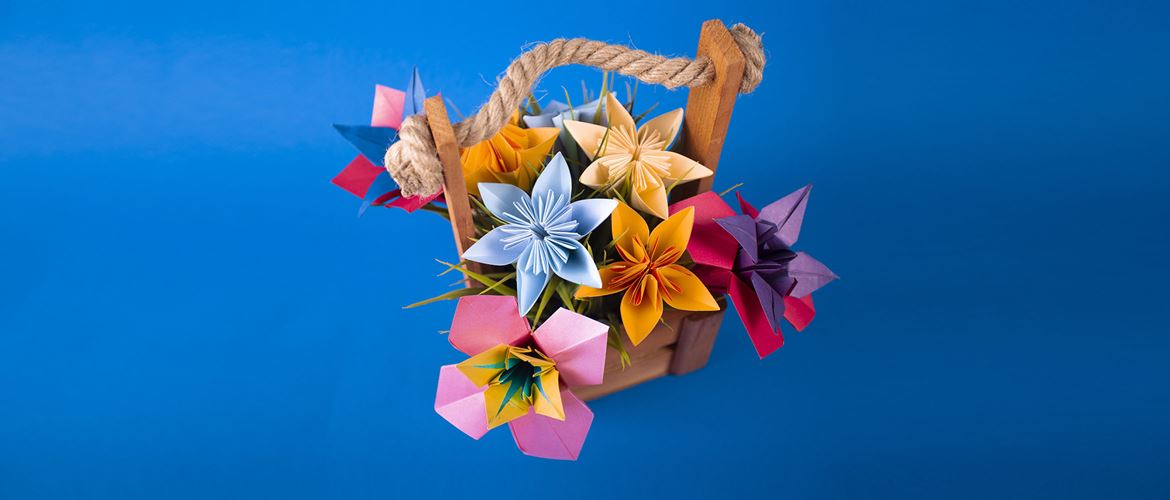 Bunch of modern spiky paper flowers on blue background