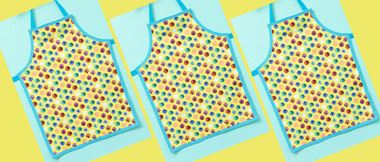 3 yellow spotty aprons with blue edges on turquoise background