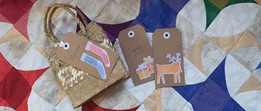 Paper Gift tags on a quilt