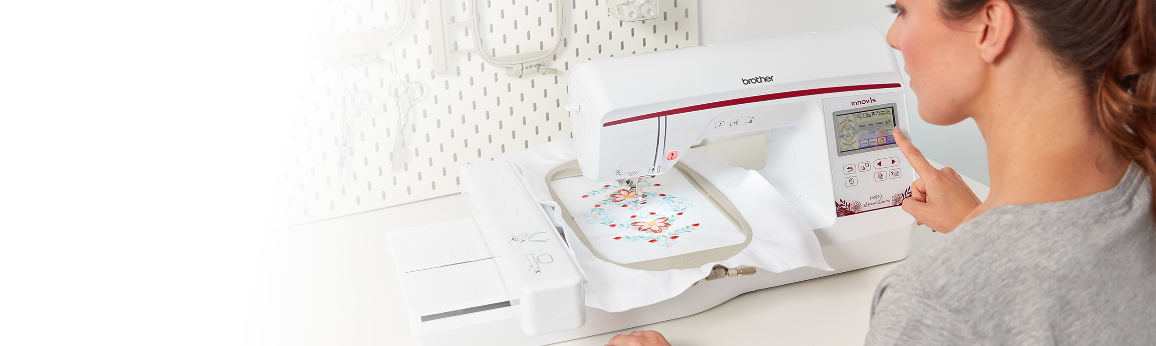 Woman using the Brother NV870E embroidery machine