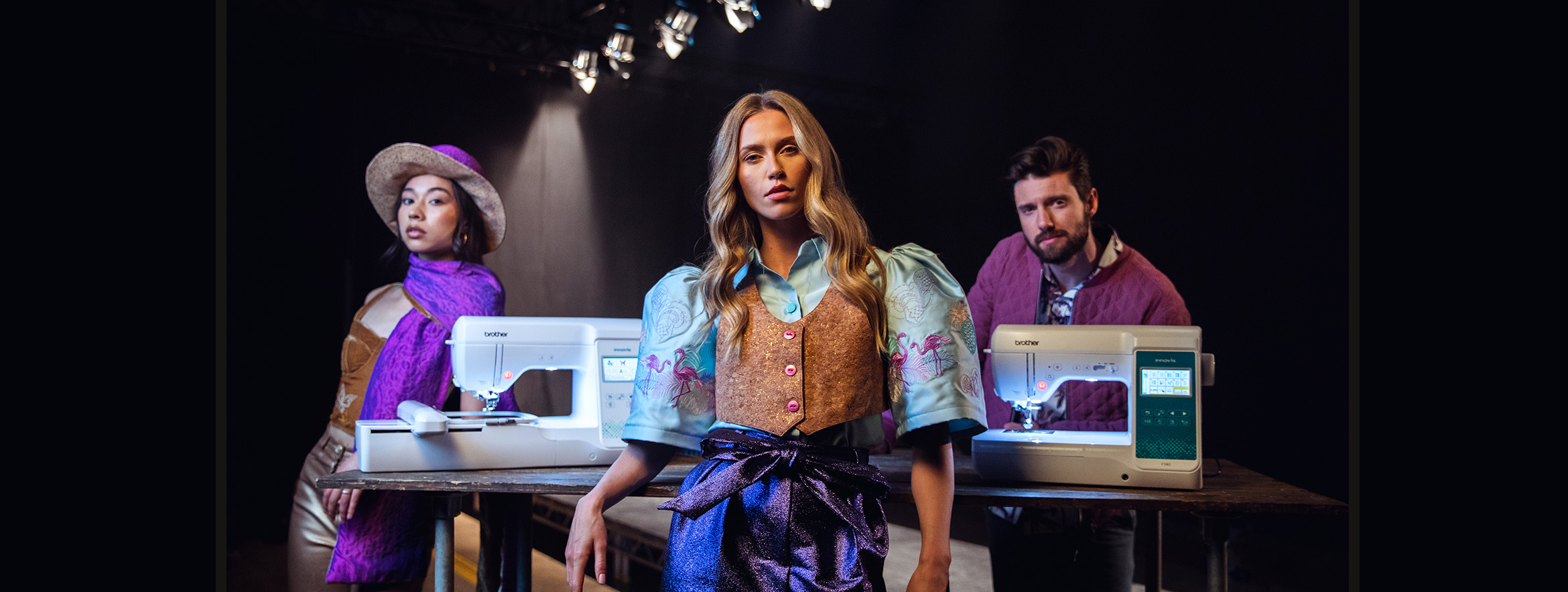 Male and female models posing with Brother F-Series Sewing- and Embroidery-machines