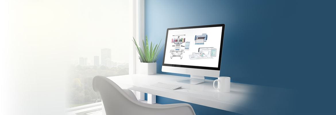 Desktop PC on white desk infront of blue wall