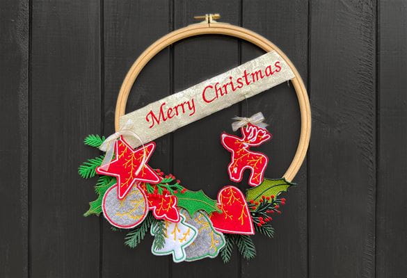Red embroidered Christmas wreath on brown background