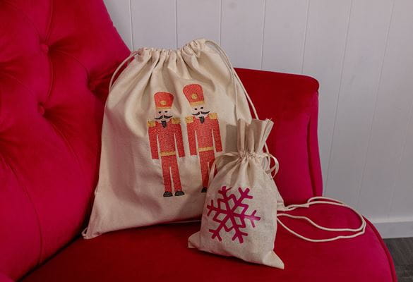 Nutcracker and snowflake drawstring bags on red chair