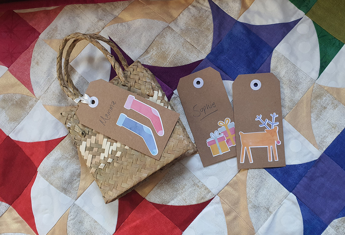 Christmas gift tags on bright star quilt