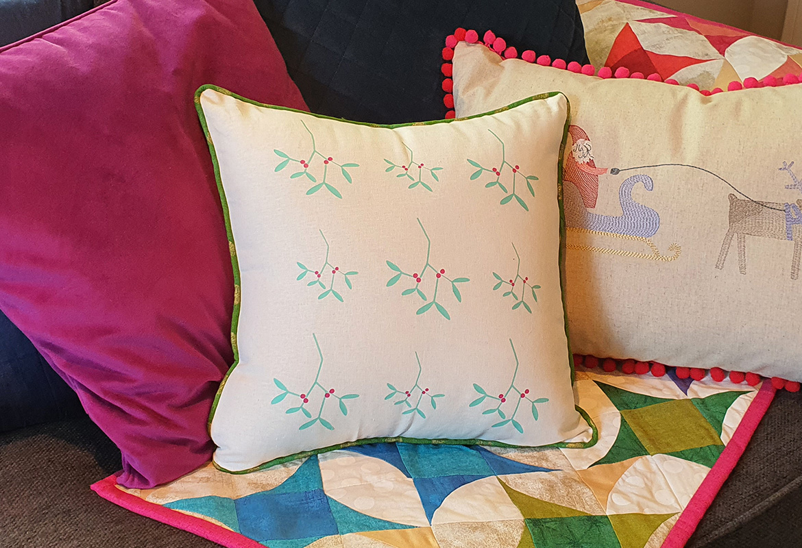 HTV mistletoe cushion on couch