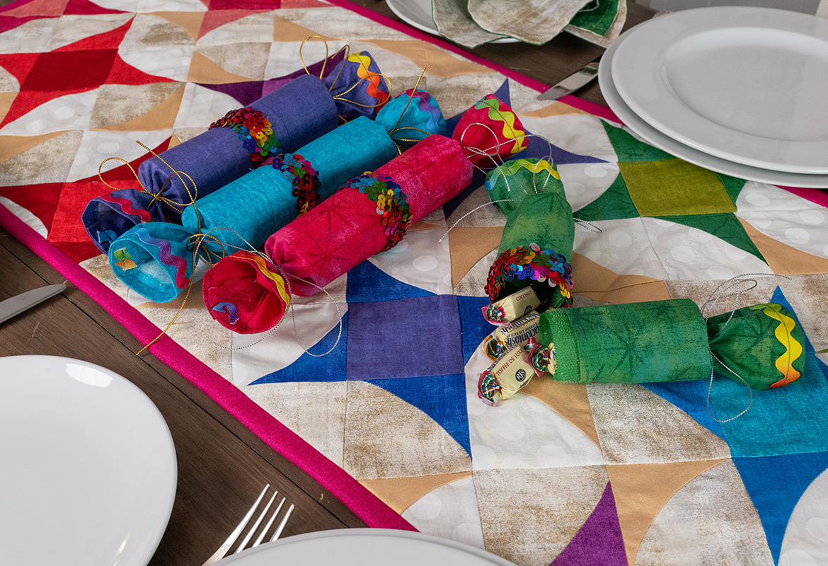 Bright fabric crackers on star quilt