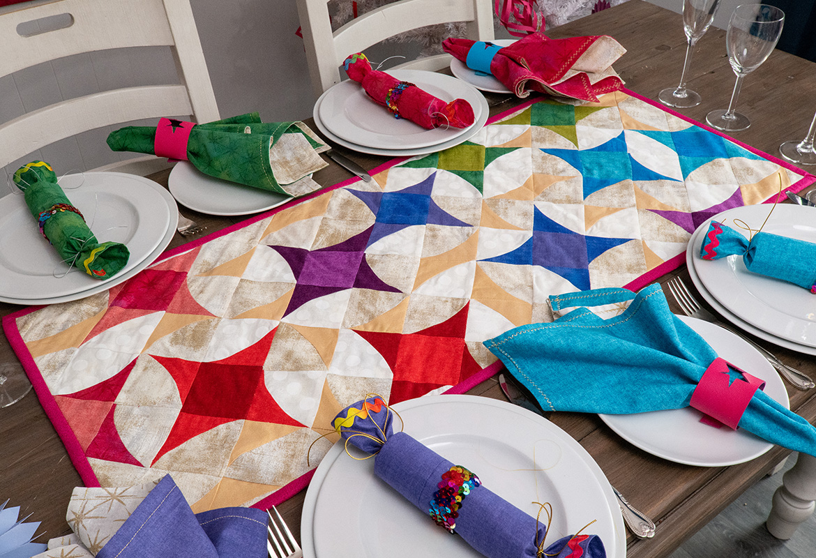 Bright star quilt on table set for Christmas