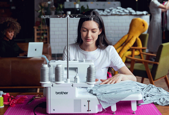 Woman sewing on Brother Airflow 300 overlocker wide table attached