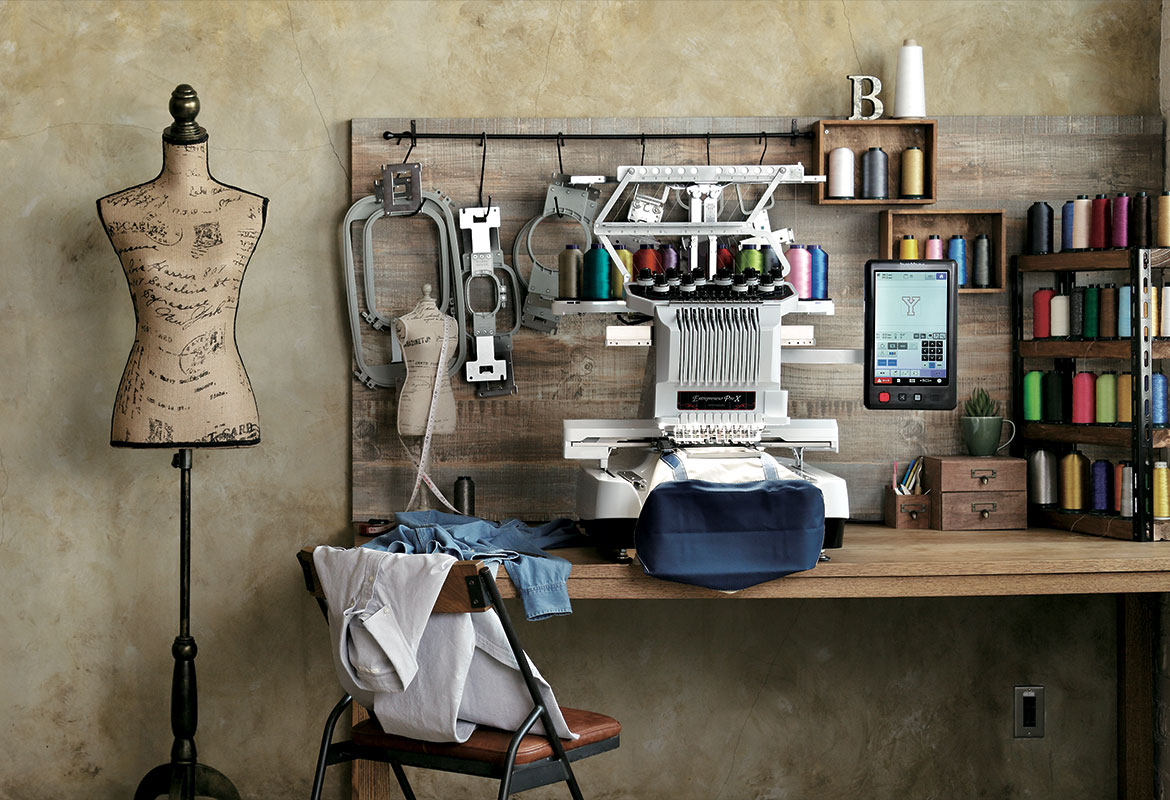 PR embroidery machine in shop setting with mannequin and frames