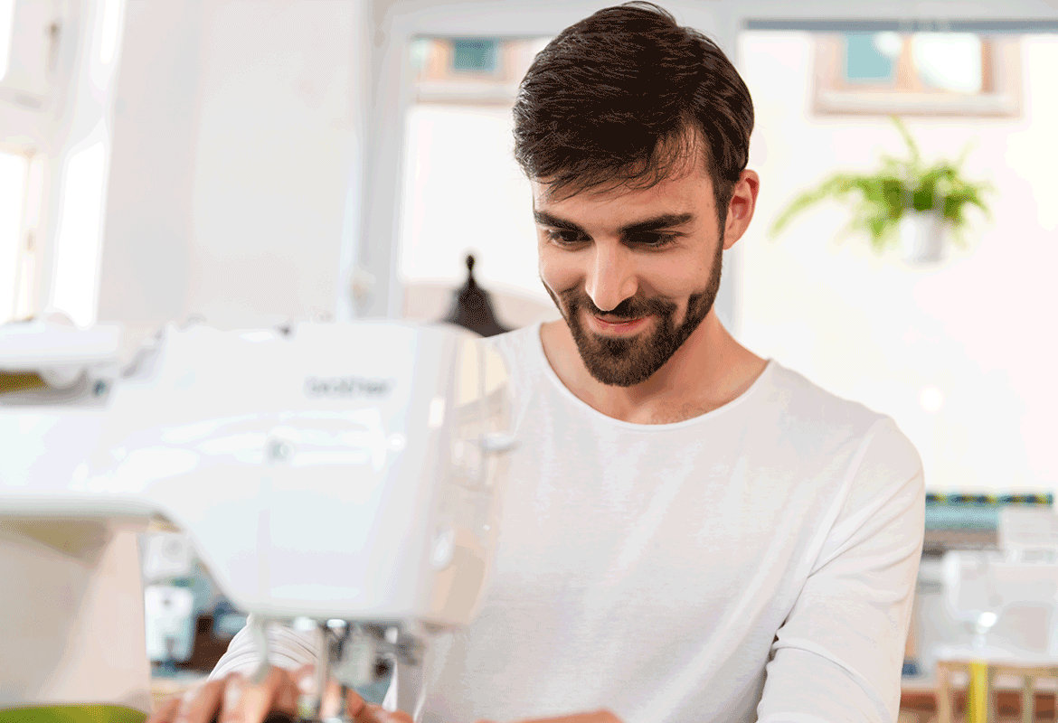 Young man sewing on a Brother A-series sewing machine
