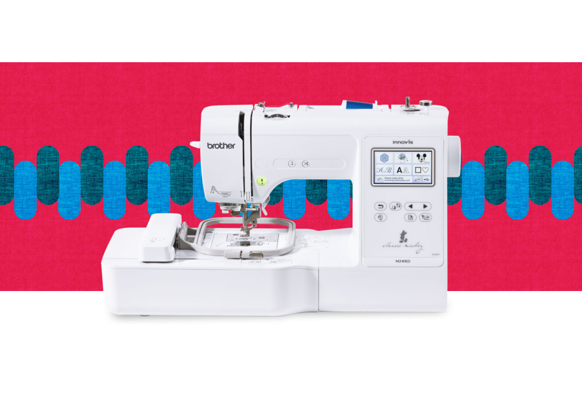 M240ED embroidery machine on a multicoloured background