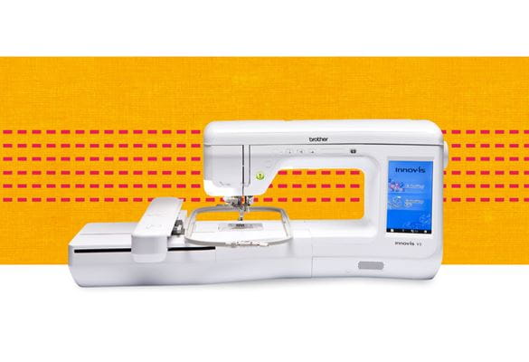 V3 embroidery machine on an orange and red pattern background