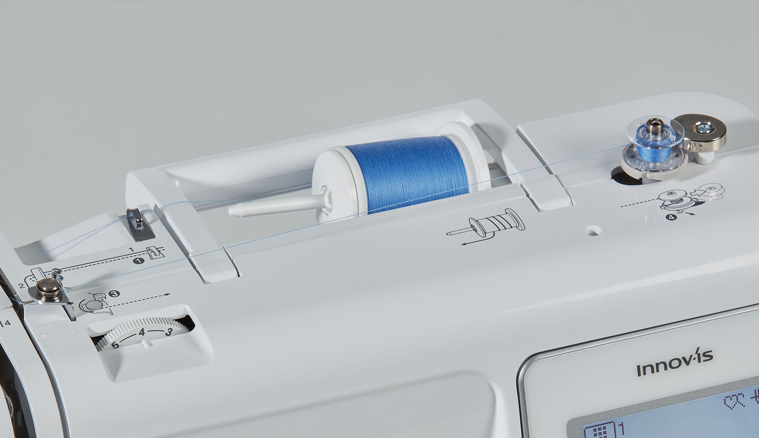 Close up of bobbin winding system and thread cutter