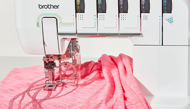 Pink shirt in large working space of Brother CV3550 coverstitch machine