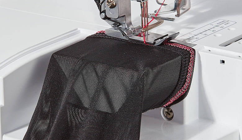 Black net fabric on free arm of Brother coverstitch machine