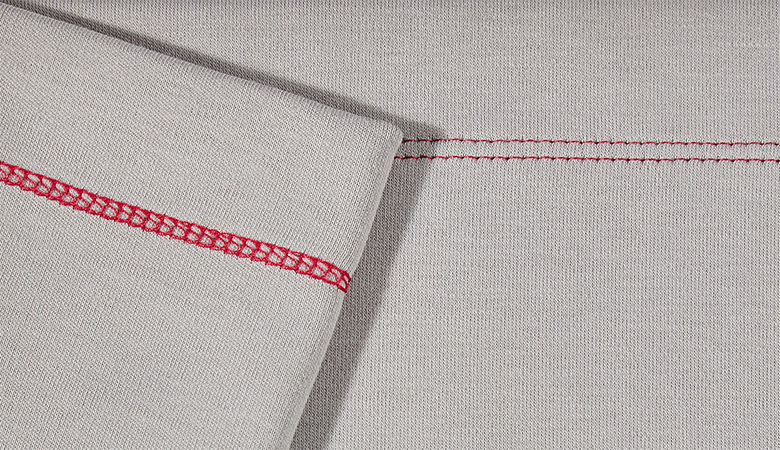 Red narrow cover stitch on grey fabric
