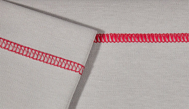 Red wide top cover stitch on grey fabric