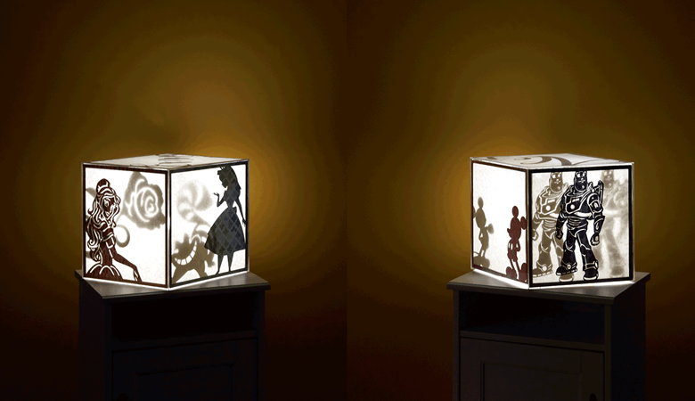 Two light boxes with silhouettes in dark room