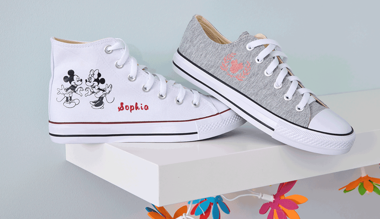 White and grey canvas shoes with Mickey designs on