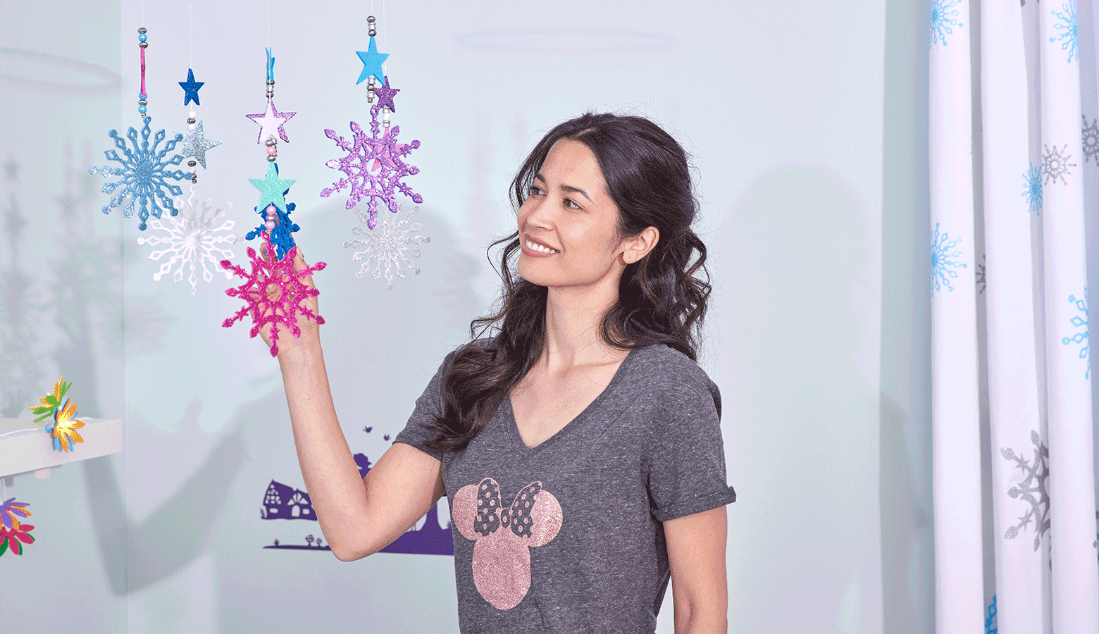 Lady touching glitter star mobile