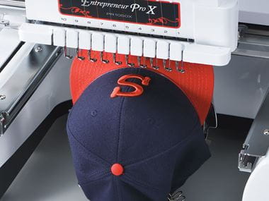 Blue and red cap in embroidery machine