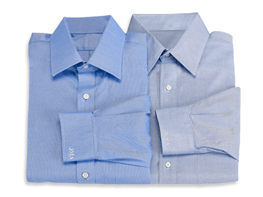 Blue formal shirts with white initials embroidered on cuffs