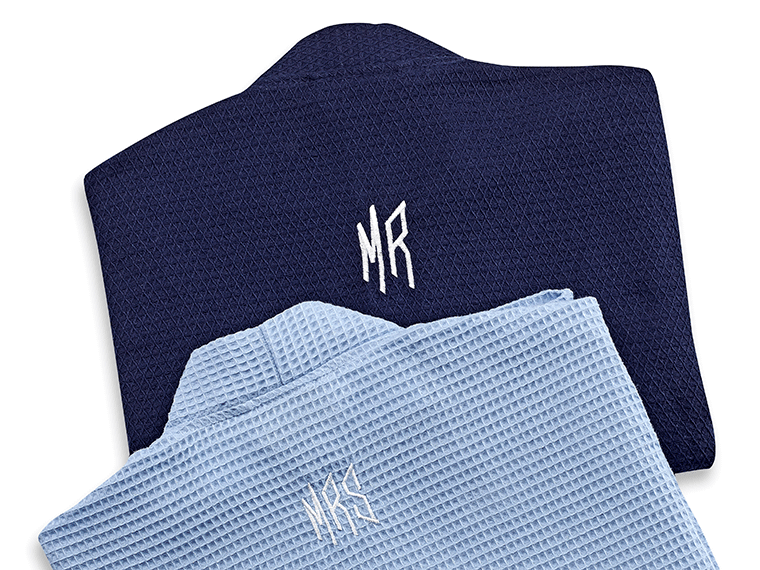 Two blue robes with Mr and Mrs embroidered on the backs