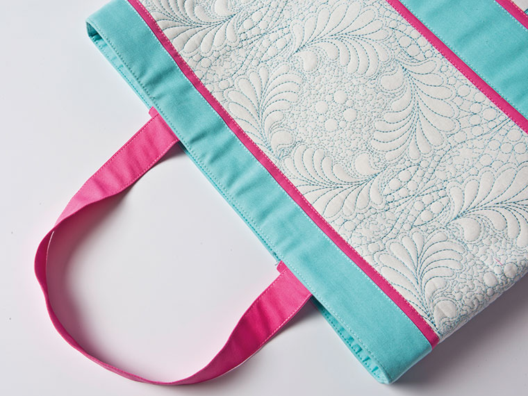 Blue and pink bag with quilting patterns stitched on