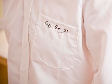 White shirt with Cafe Bar 21 embroidered on