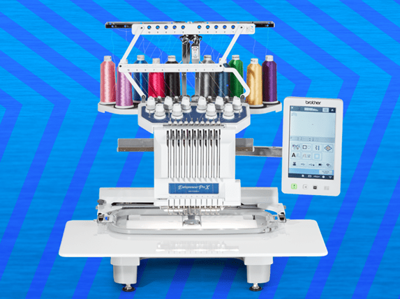 Brother PR1055X embroidery machine on blue zigzag background