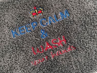 Keep calm embroidery on dark grey towel