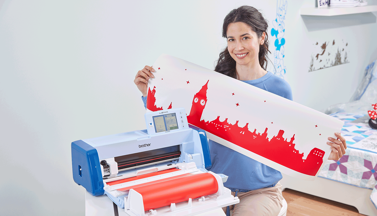 Lady holding a long vinyl silhouette cut out of a cityline