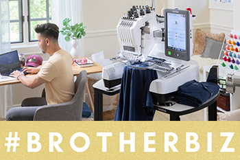 Man sitting in front of laptop with PR embroidery machine behind him