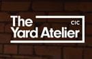 The Yard Atelier Logo on dark stone wall background