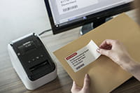 QL-800 label printer with address label containing black and red print