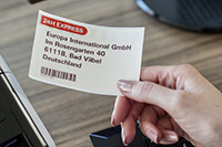 Address label with red and black print 