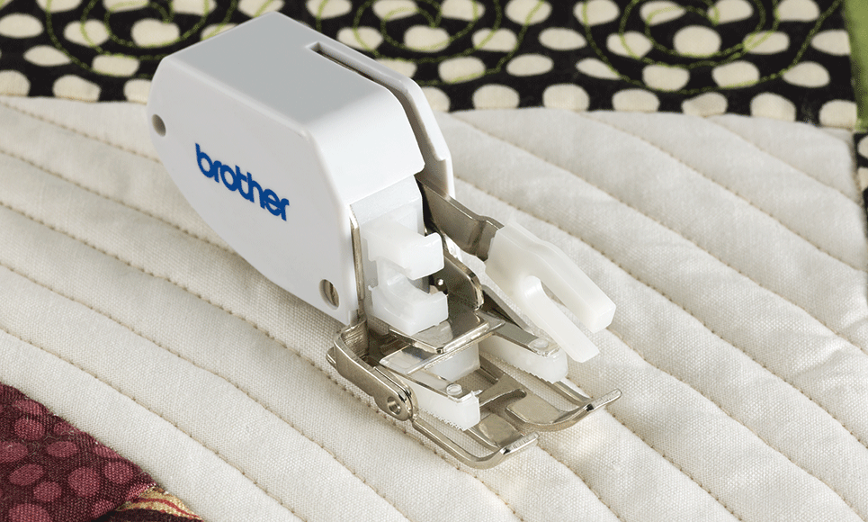 Walking foot attachment on white and black quilt with parallel sewing